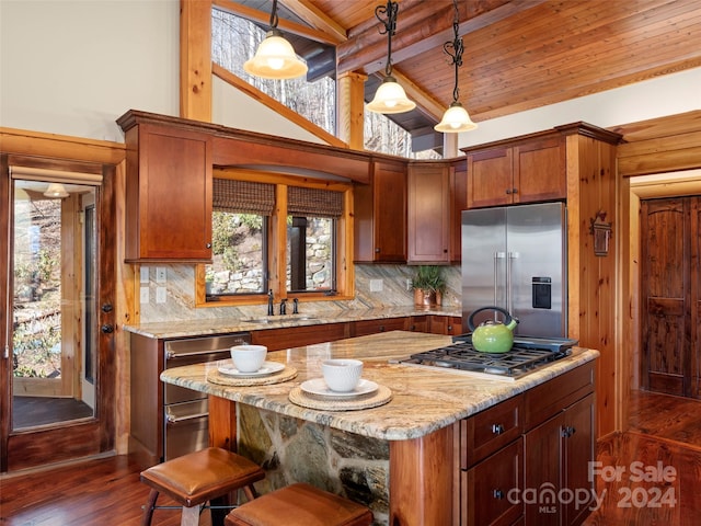 kitchen featuring tasteful backsplash, wood ceiling, hanging light fixtures, and stainless steel appliances