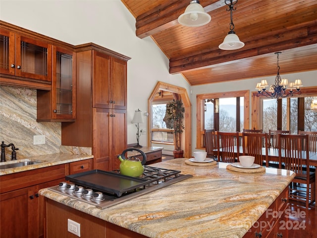 kitchen featuring stainless steel gas stovetop, wooden ceiling, decorative light fixtures, vaulted ceiling with beams, and sink