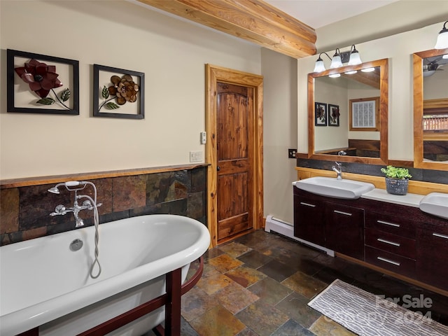 bathroom featuring baseboard heating, tile walls, a bathtub, and vanity