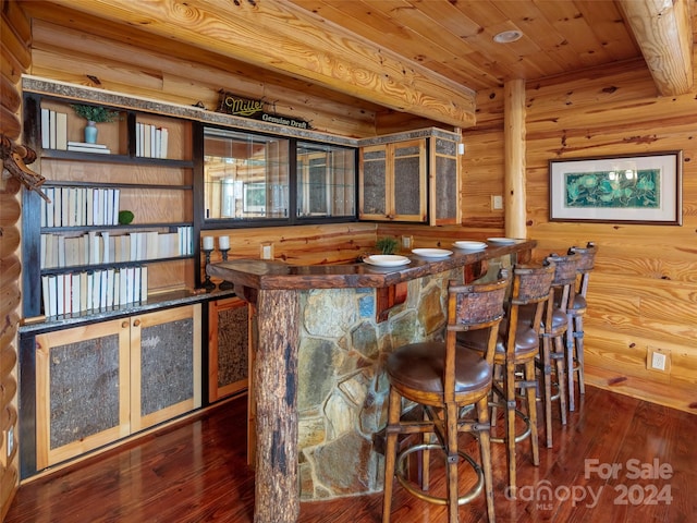 bar featuring wood ceiling, dark hardwood / wood-style flooring, and beamed ceiling