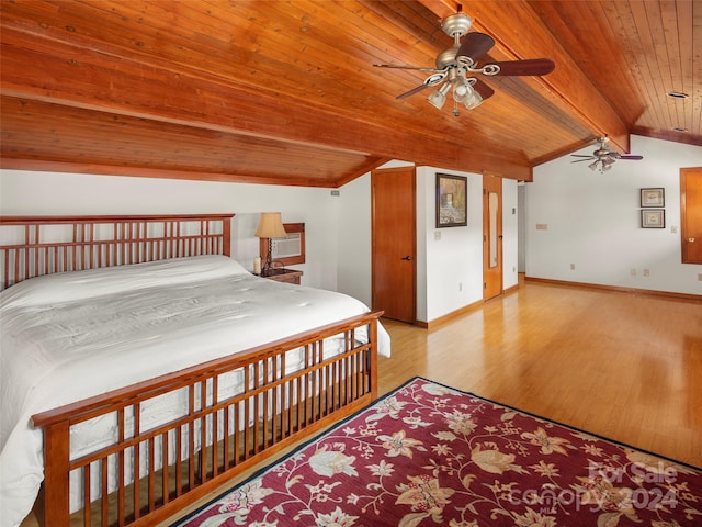 unfurnished bedroom featuring ceiling fan, vaulted ceiling with beams, light wood-type flooring, and wooden ceiling