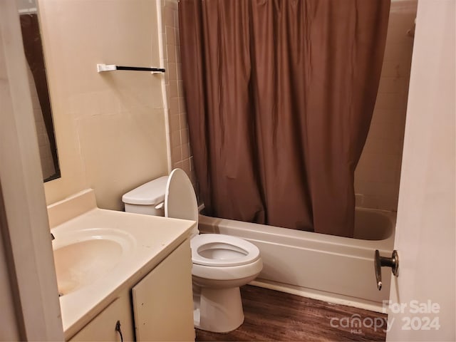 full bathroom with vanity, wood-type flooring, toilet, and shower / bathtub combination with curtain