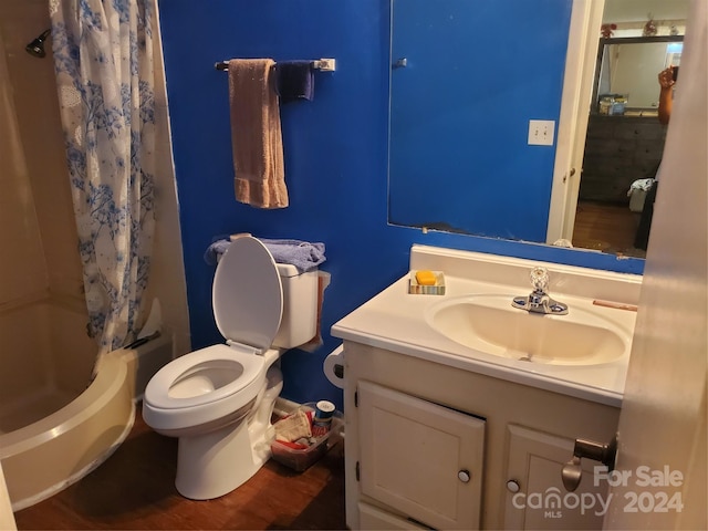 full bathroom with toilet, vanity, shower / bathtub combination with curtain, and hardwood / wood-style floors