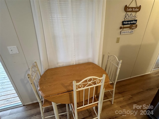 dining room with dark hardwood / wood-style flooring