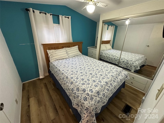 bedroom featuring dark hardwood / wood-style flooring, ceiling fan, a closet, and lofted ceiling