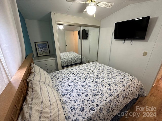 bedroom featuring vaulted ceiling, a closet, ceiling fan, and hardwood / wood-style flooring