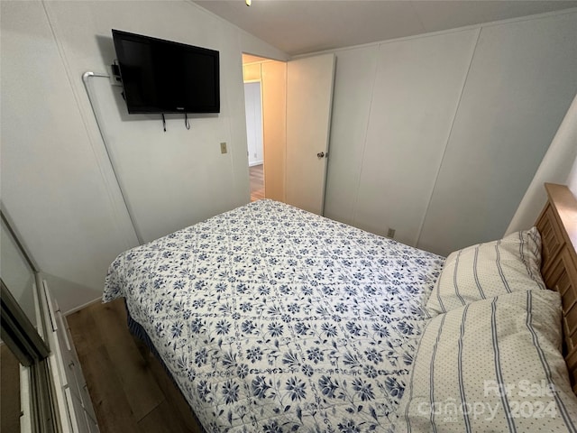 bedroom featuring lofted ceiling and hardwood / wood-style flooring