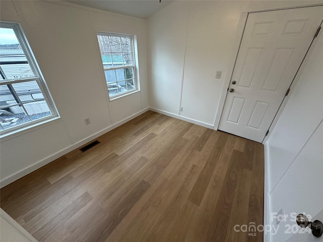 unfurnished bedroom with light wood-type flooring