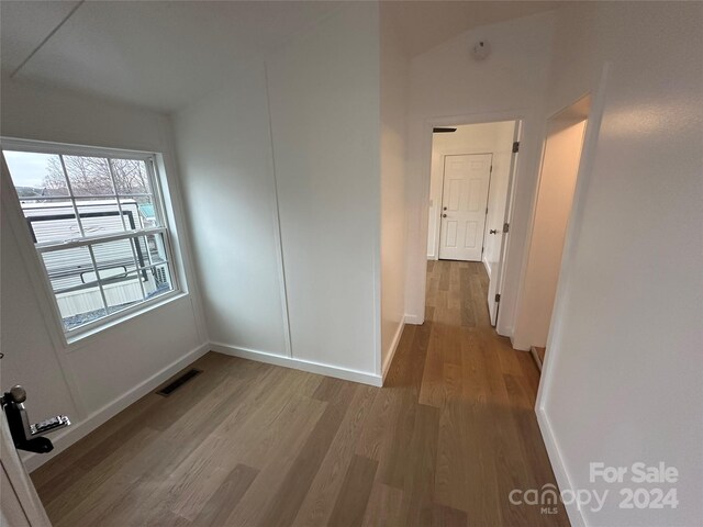 corridor with hardwood / wood-style floors