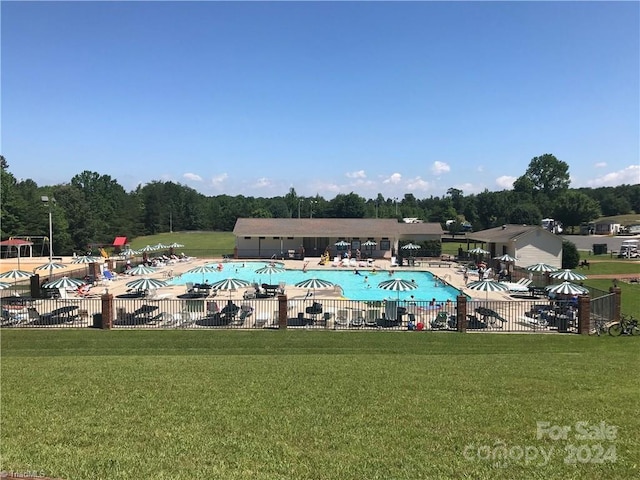 view of swimming pool featuring a yard and a patio