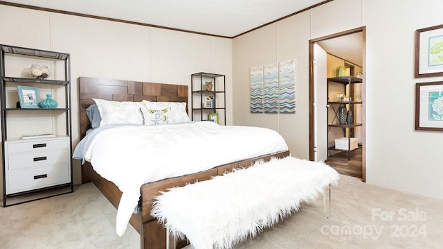 carpeted bedroom with ornamental molding