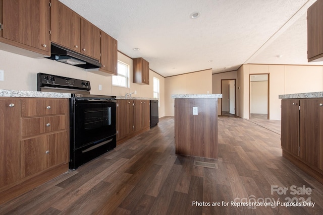 kitchen with a kitchen island, dark hardwood / wood-style floors, a textured ceiling, black appliances, and lofted ceiling