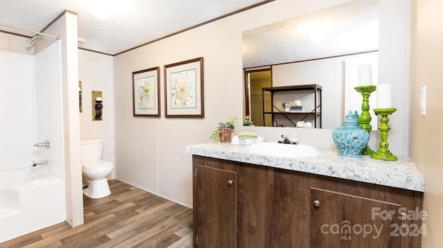 full bathroom featuring toilet, a textured ceiling, vanity, and hardwood / wood-style flooring