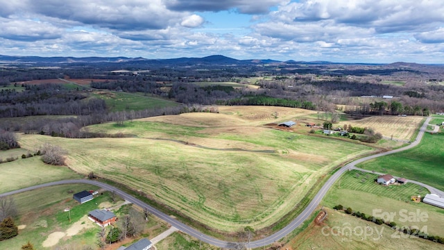 drone / aerial view featuring a mountain view and a rural view