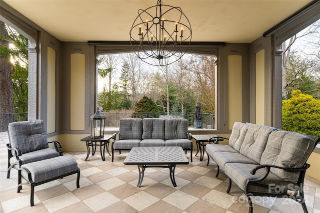 sunroom / solarium with an inviting chandelier