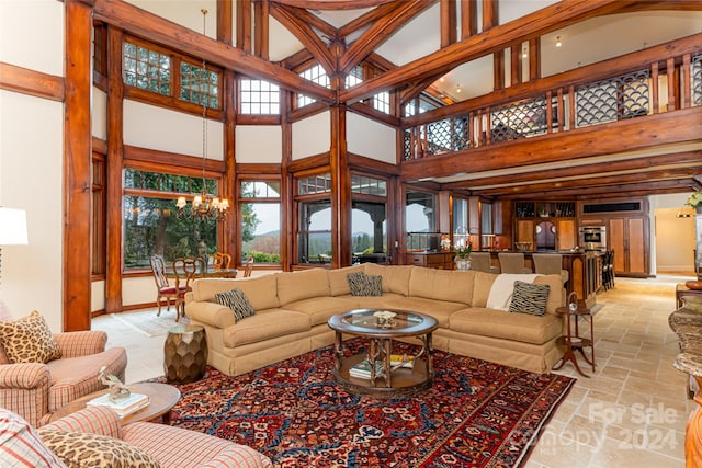 living room featuring a high ceiling and a chandelier