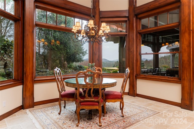 sunroom / solarium featuring a chandelier