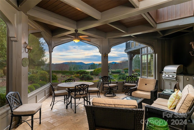 view of patio / terrace featuring ceiling fan, an outdoor living space, a mountain view, and area for grilling