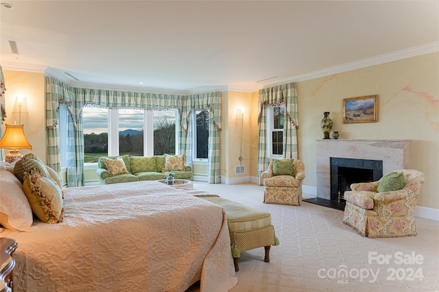 bedroom featuring crown molding, light carpet, and a fireplace