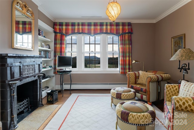 living area with wood-type flooring, a baseboard heating unit, ornamental molding, and a tiled fireplace