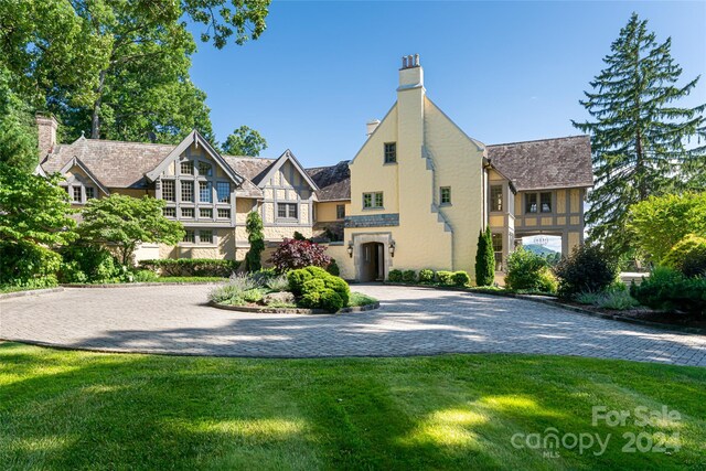 tudor house featuring a front lawn