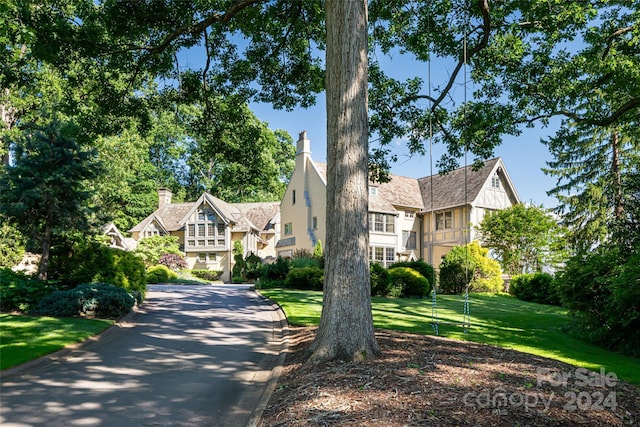 tudor home with a front yard