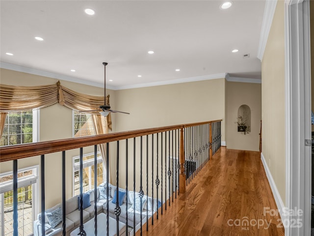 hall featuring ornamental molding and hardwood / wood-style floors