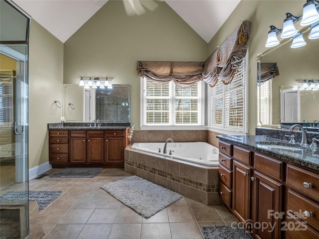 bathroom featuring vanity, high vaulted ceiling, tile patterned floors, and plus walk in shower