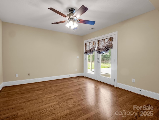 spare room featuring french doors, ceiling fan, and hardwood / wood-style floors