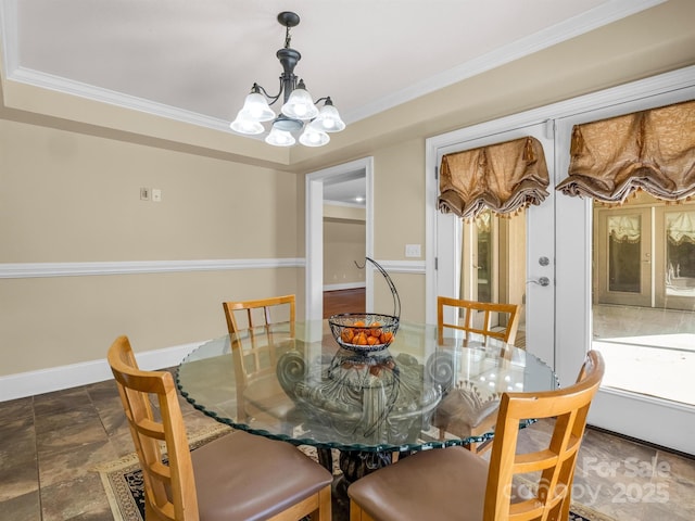 dining room featuring crown molding, french doors, and a chandelier