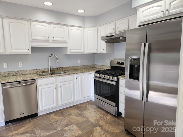 kitchen with white cabinetry, sink, light stone counters, and appliances with stainless steel finishes