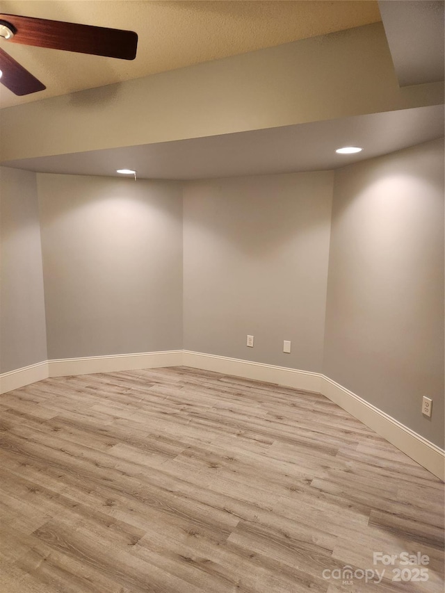 spare room featuring ceiling fan and light hardwood / wood-style floors