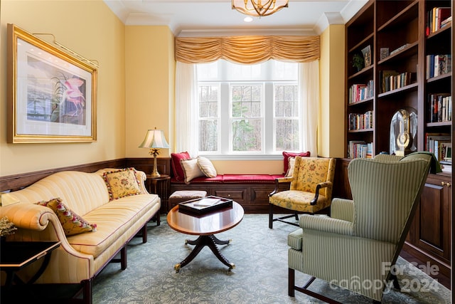 living area featuring crown molding