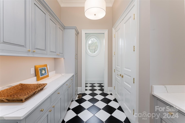 interior space with light tile patterned floors and ornamental molding