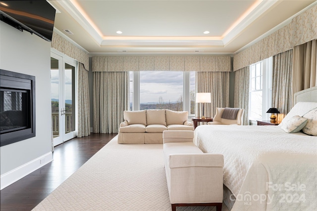 bedroom featuring dark wood-type flooring, multiple windows, and access to exterior