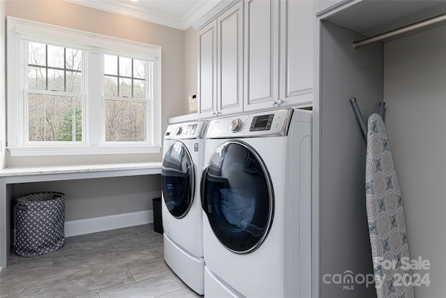 clothes washing area featuring washer and dryer, crown molding, cabinets, and light tile patterned flooring