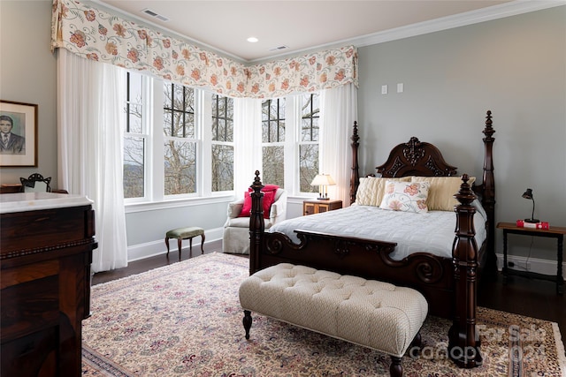 bedroom featuring multiple windows, ornamental molding, and dark hardwood / wood-style floors