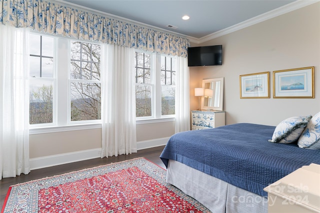 bedroom featuring crown molding, dark hardwood / wood-style flooring, and multiple windows