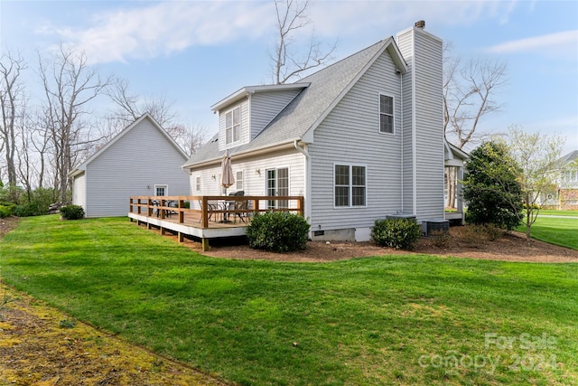 back of house featuring central air condition unit, a wooden deck, and a lawn