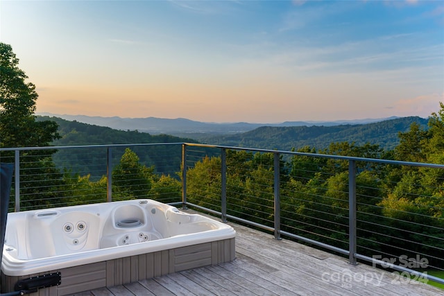 deck at dusk featuring a mountain view