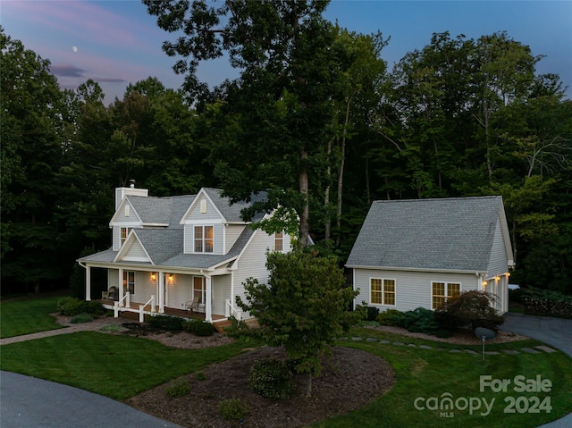 view of front of property featuring a lawn and a porch