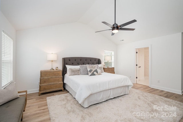 bedroom with ensuite bathroom, light hardwood / wood-style floors, ceiling fan, and lofted ceiling