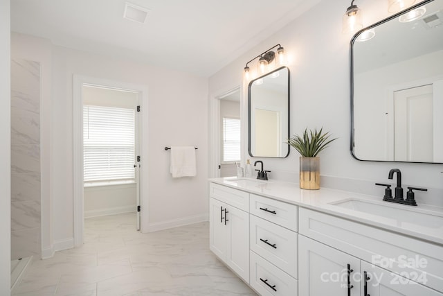 bathroom featuring dual sinks, large vanity, and tile floors