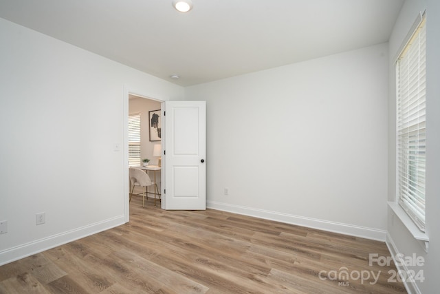 spare room featuring wood-type flooring