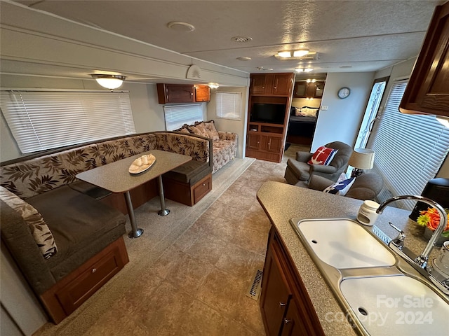 interior space with a textured ceiling and sink