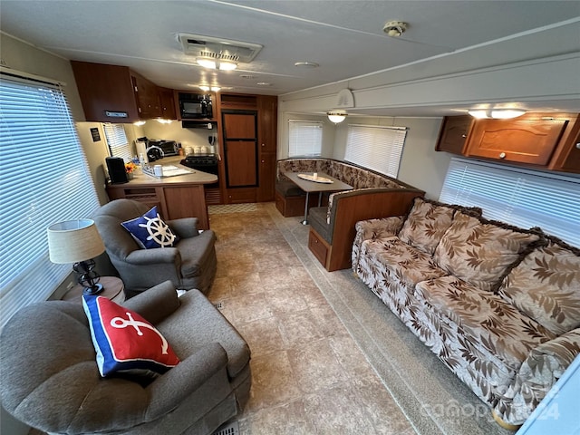 interior space with light tile floors and ceiling fan