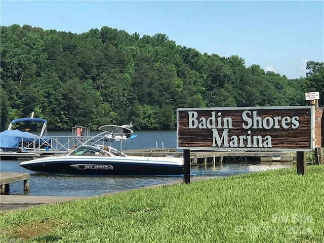 dock area featuring a water view and a yard