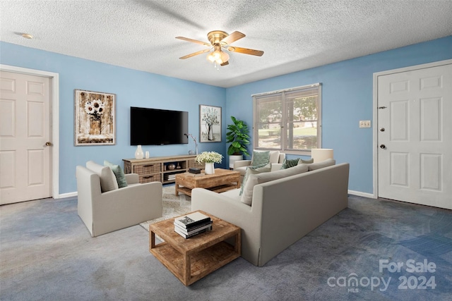 carpeted living room with ceiling fan and a textured ceiling