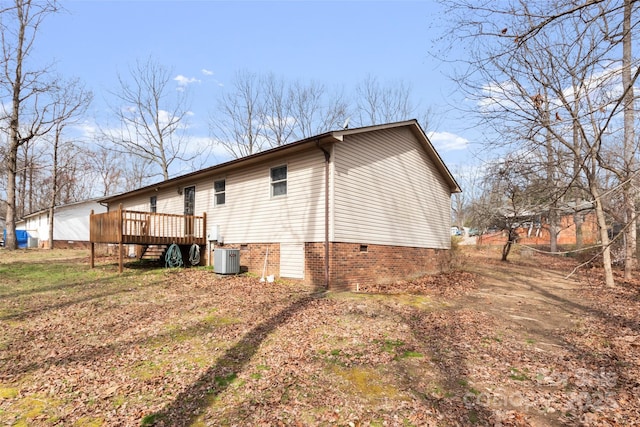 view of property exterior with central AC and a deck