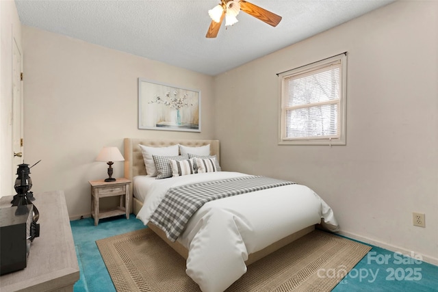 bedroom featuring a ceiling fan, baseboards, carpet floors, and a textured ceiling